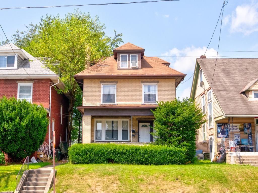 a front view of a house with garden