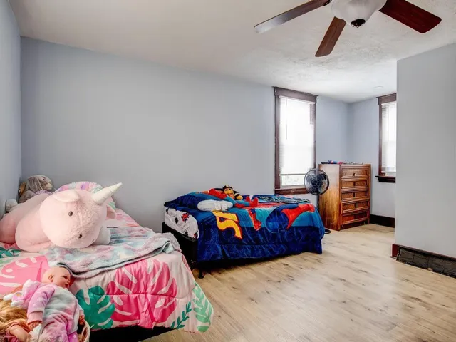 a bedroom with two beds and a couch