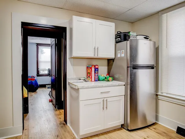 a kitchen with a refrigerator and a stove
