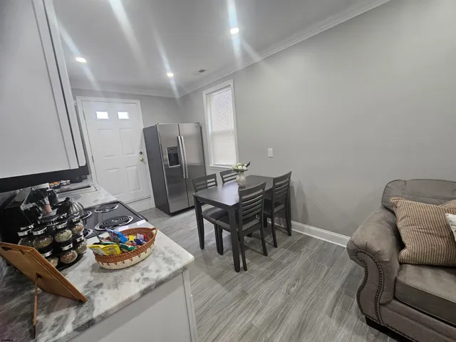 a view of a workspace with furniture and wooden floor