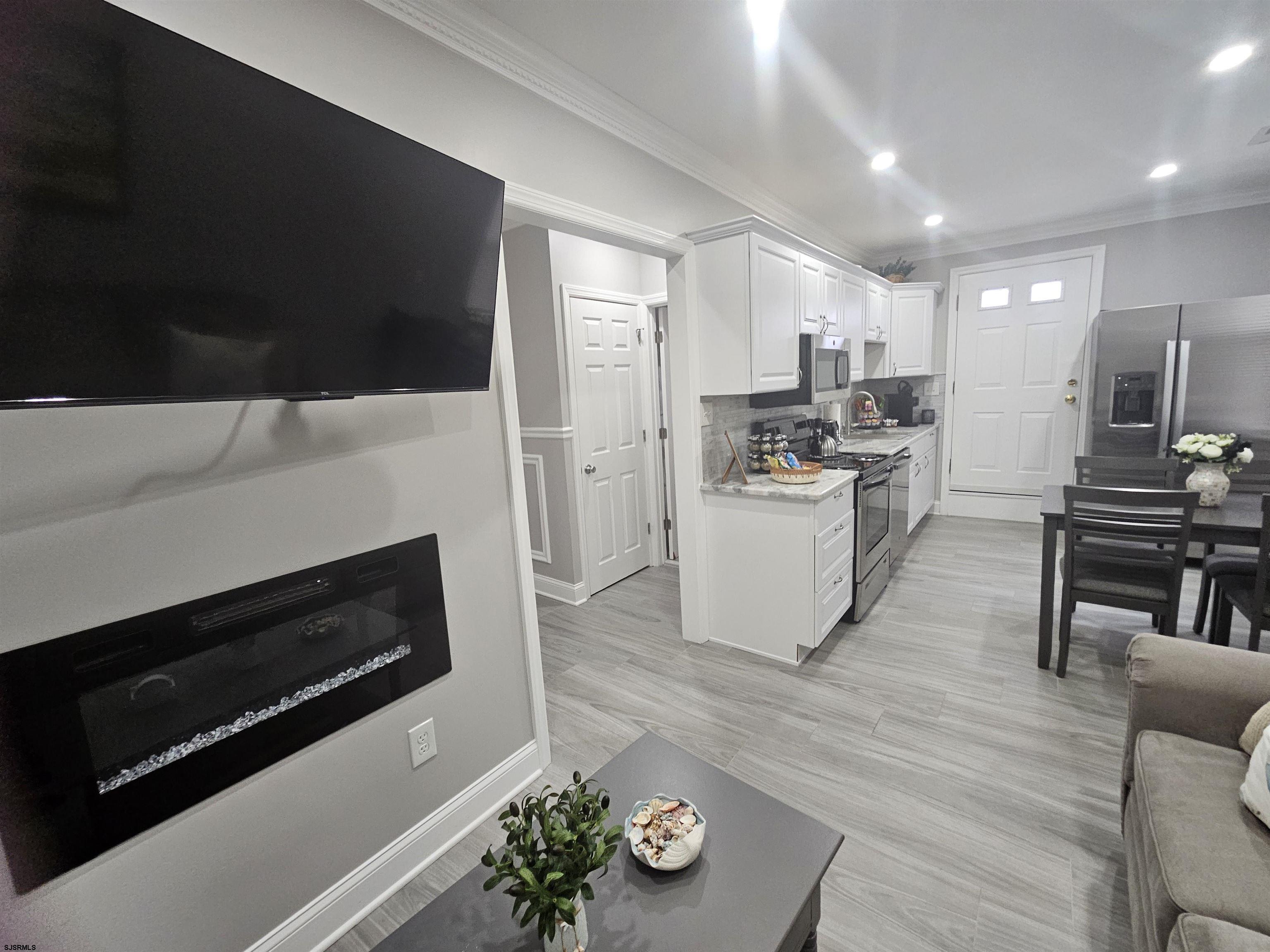 4009 Ventnor, Unit 2 Atlantic City, NJ 08401 - Photo 13 of 32 a kitchen with microwave a stove and cabinets