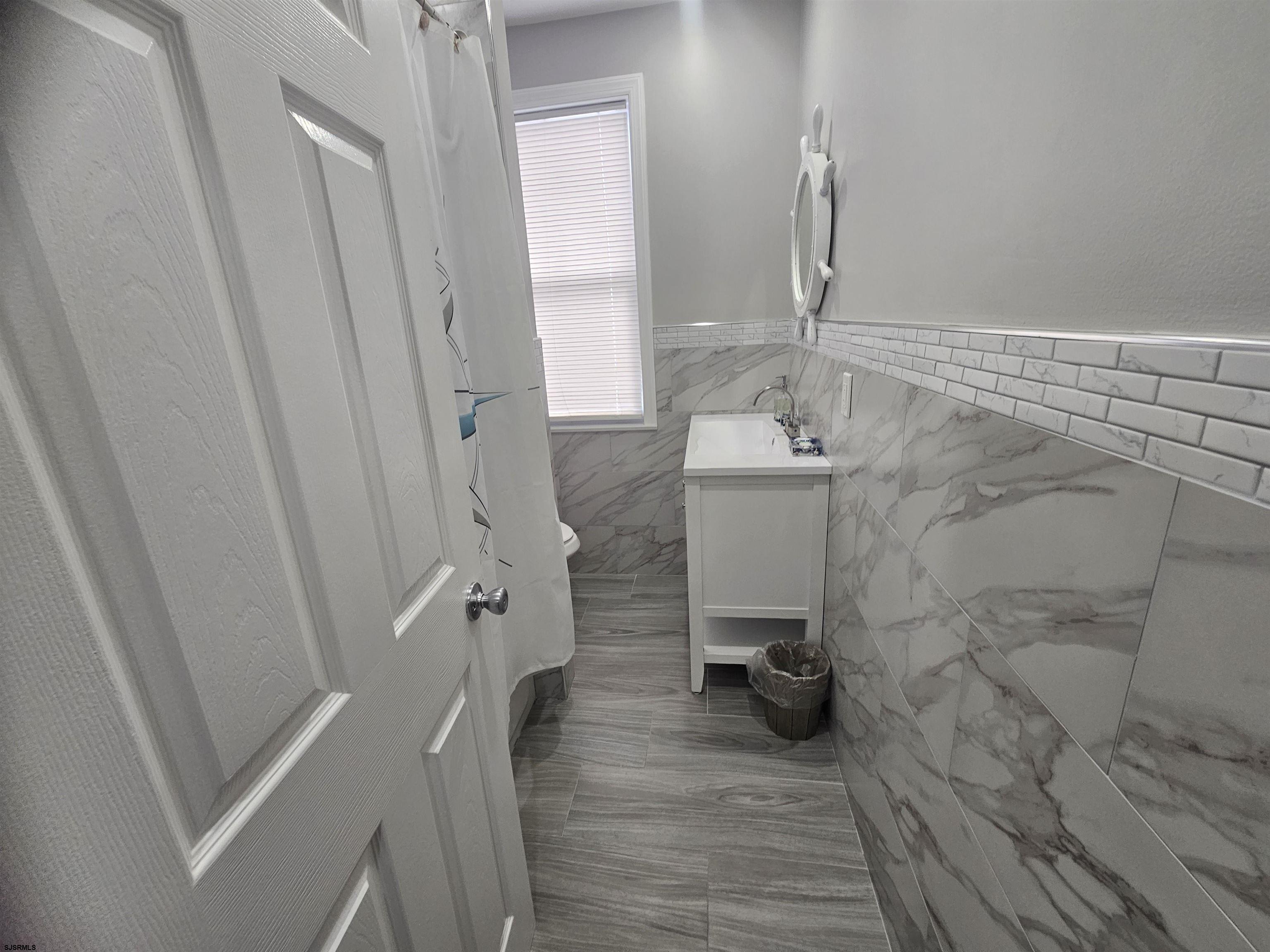 4009 Ventnor, Unit 2 Atlantic City, NJ 08401 - Photo 14 of 32 a bathroom with a sink a toilet and shower
