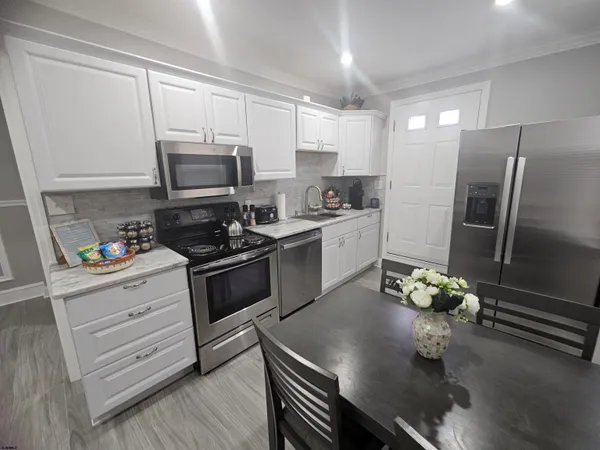 a kitchen with a sink stainless steel appliances and cabinets