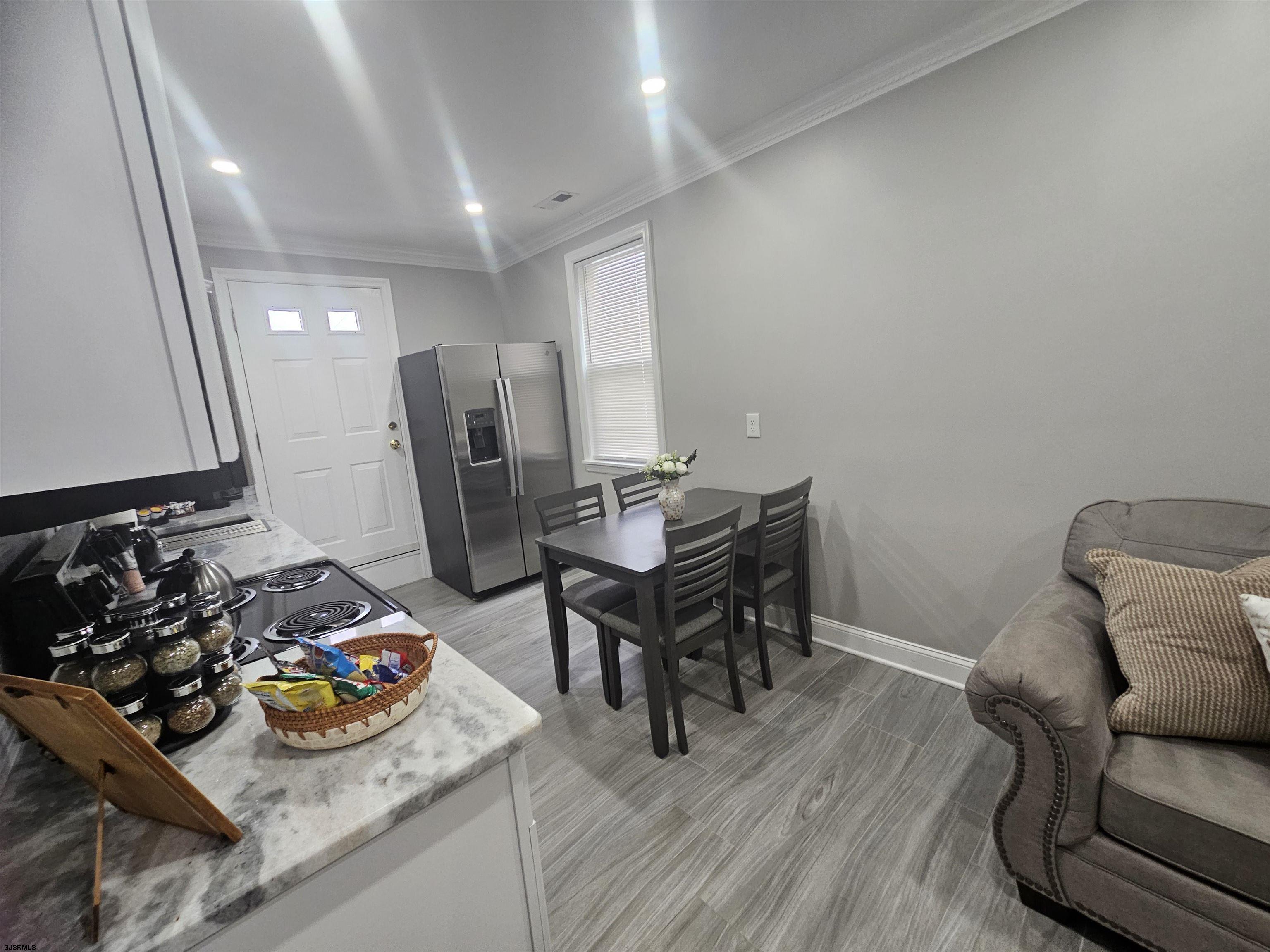4009 Ventnor, Unit 2 Atlantic City, NJ 08401 - Photo 17 of 32 a view of a workspace with furniture and wooden floor