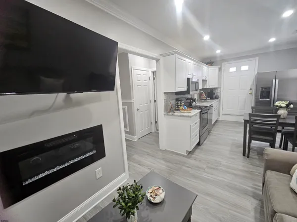 a kitchen with microwave a stove and cabinets