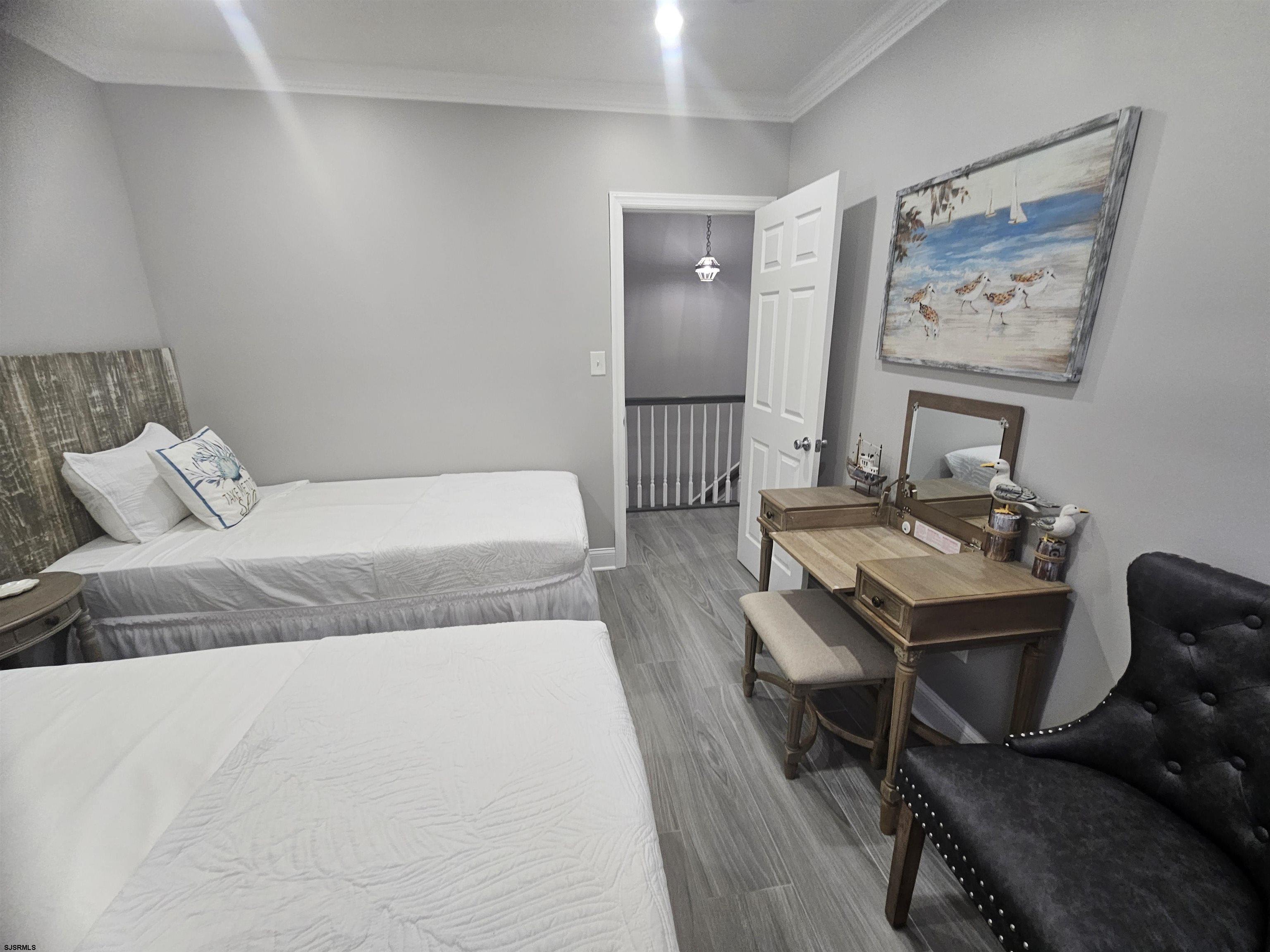 4009 Ventnor, Unit 2 Atlantic City, NJ 08401 - Photo 19 of 32 a bedroom with a bed and a table in it