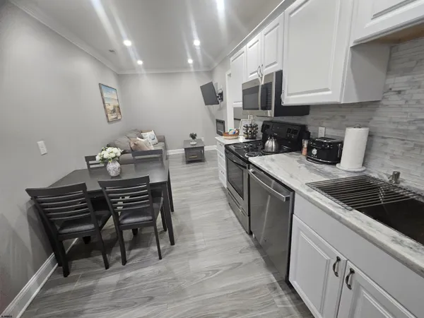 a kitchen with a sink appliances and cabinets