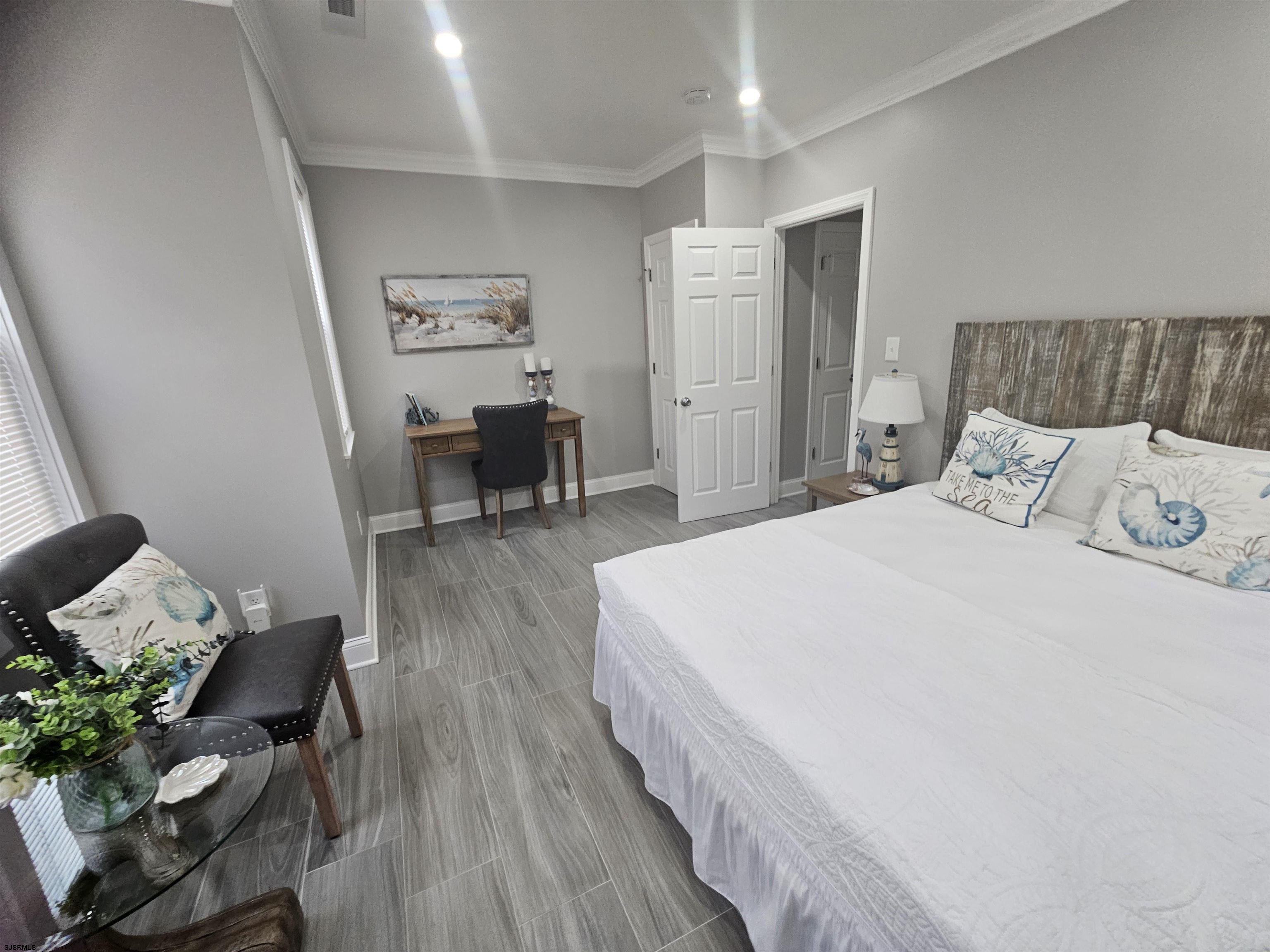 4009 Ventnor, Unit 2 Atlantic City, NJ 08401 - Photo 22 of 32 a spacious bedroom with a bed and a table in it