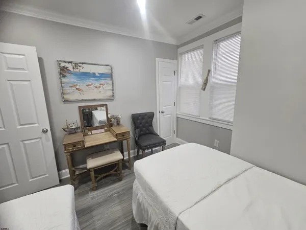 a bedroom with a bed and a chair