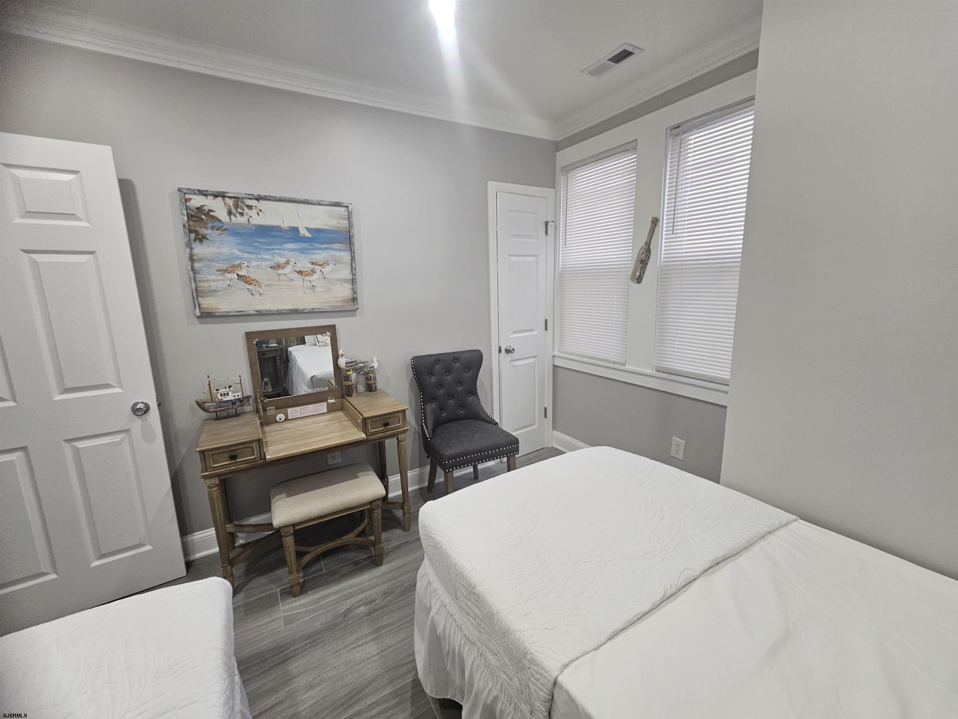 4009 Ventnor, Unit 2 Atlantic City, NJ 08401 - Photo 24 of 32 a bedroom with a bed and a chair