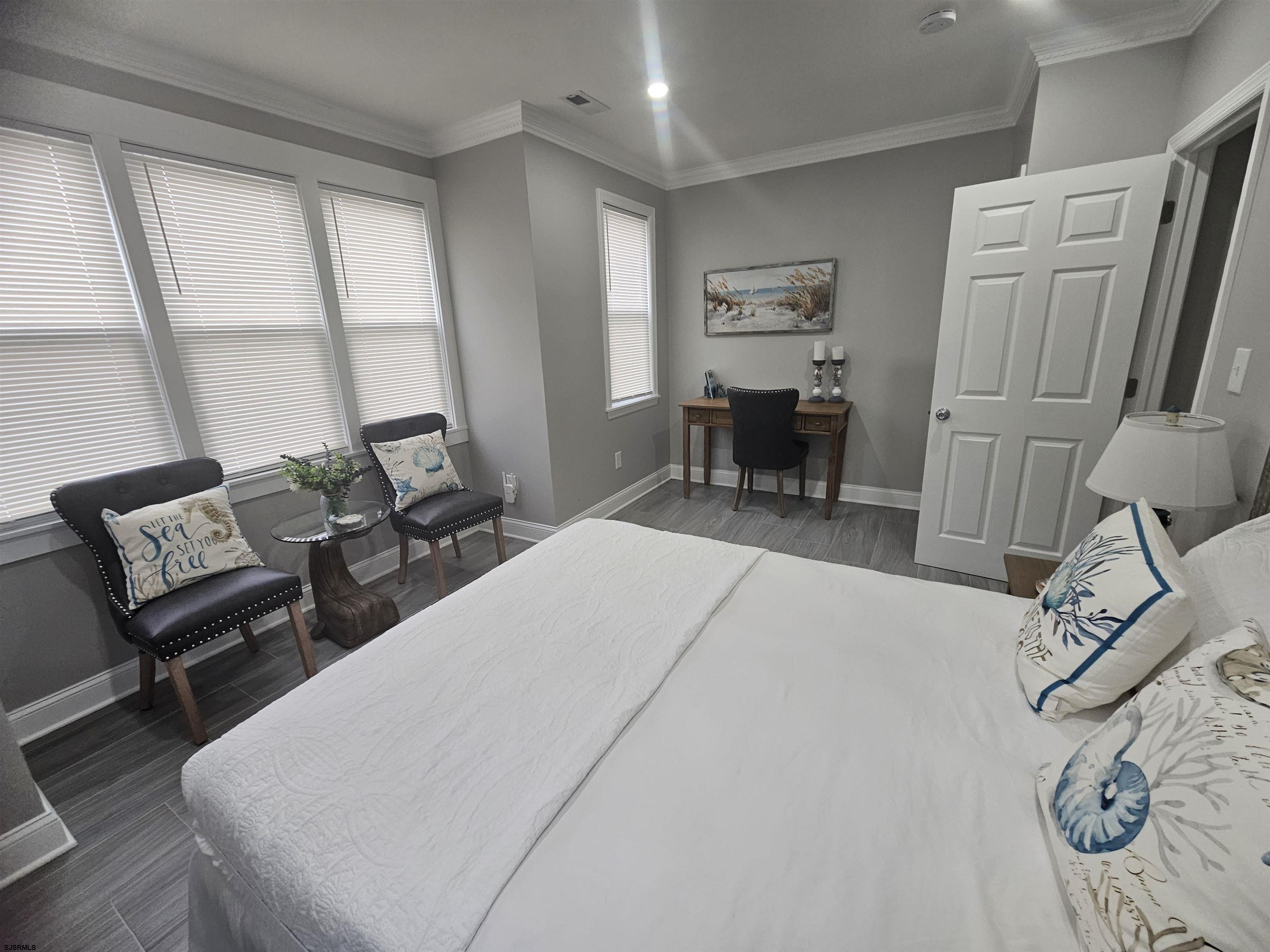 4009 Ventnor, Unit 2 Atlantic City, NJ 08401 - Photo 24 of 32 a bed room with a bed and a chair