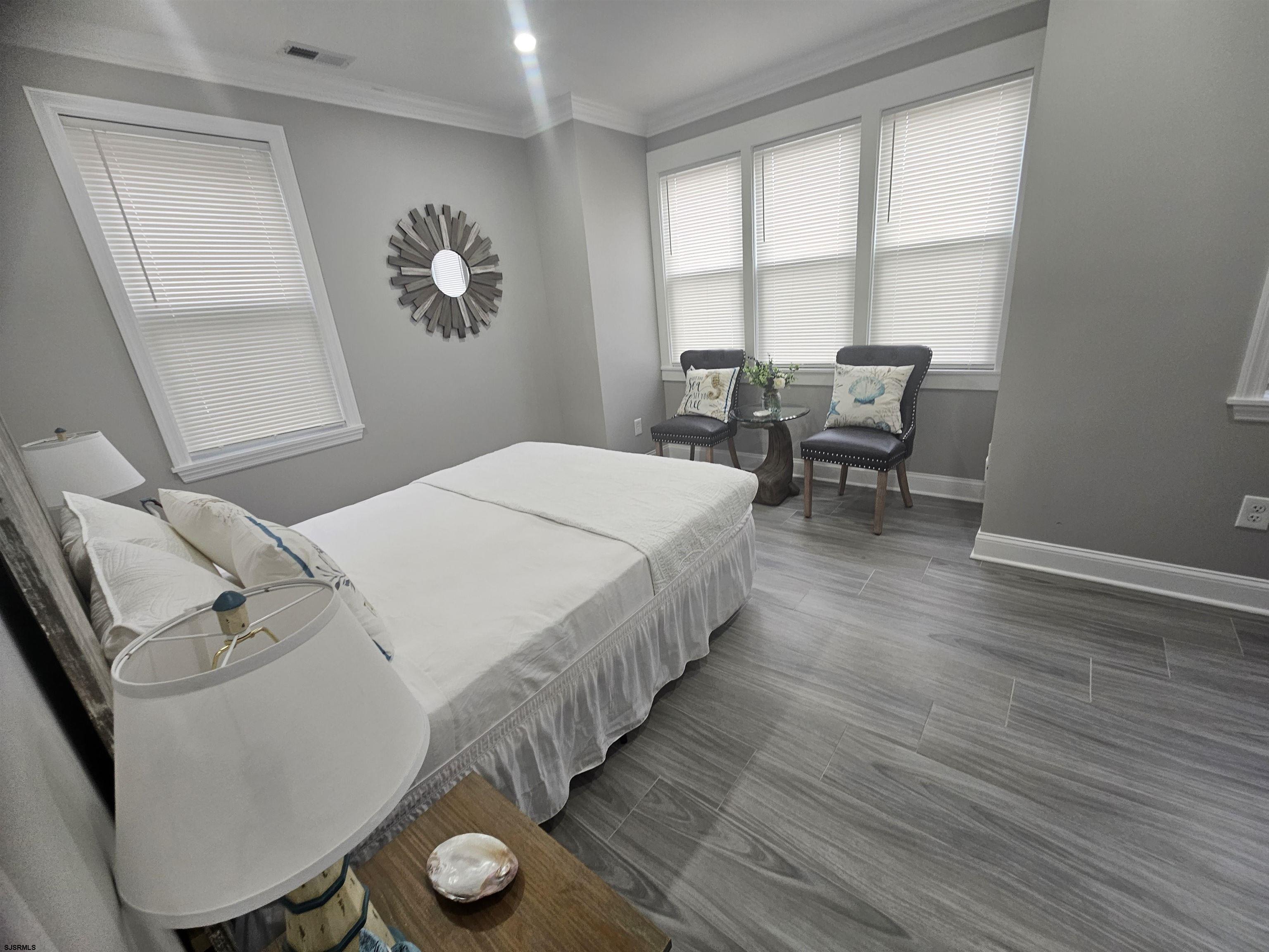 4009 Ventnor, Unit 2 Atlantic City, NJ 08401 - Photo 27 of 32 a bedroom with a bed and a table