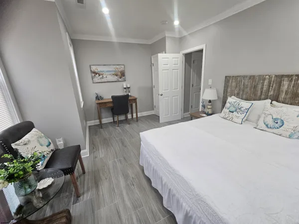 a spacious bedroom with a bed and a table in it