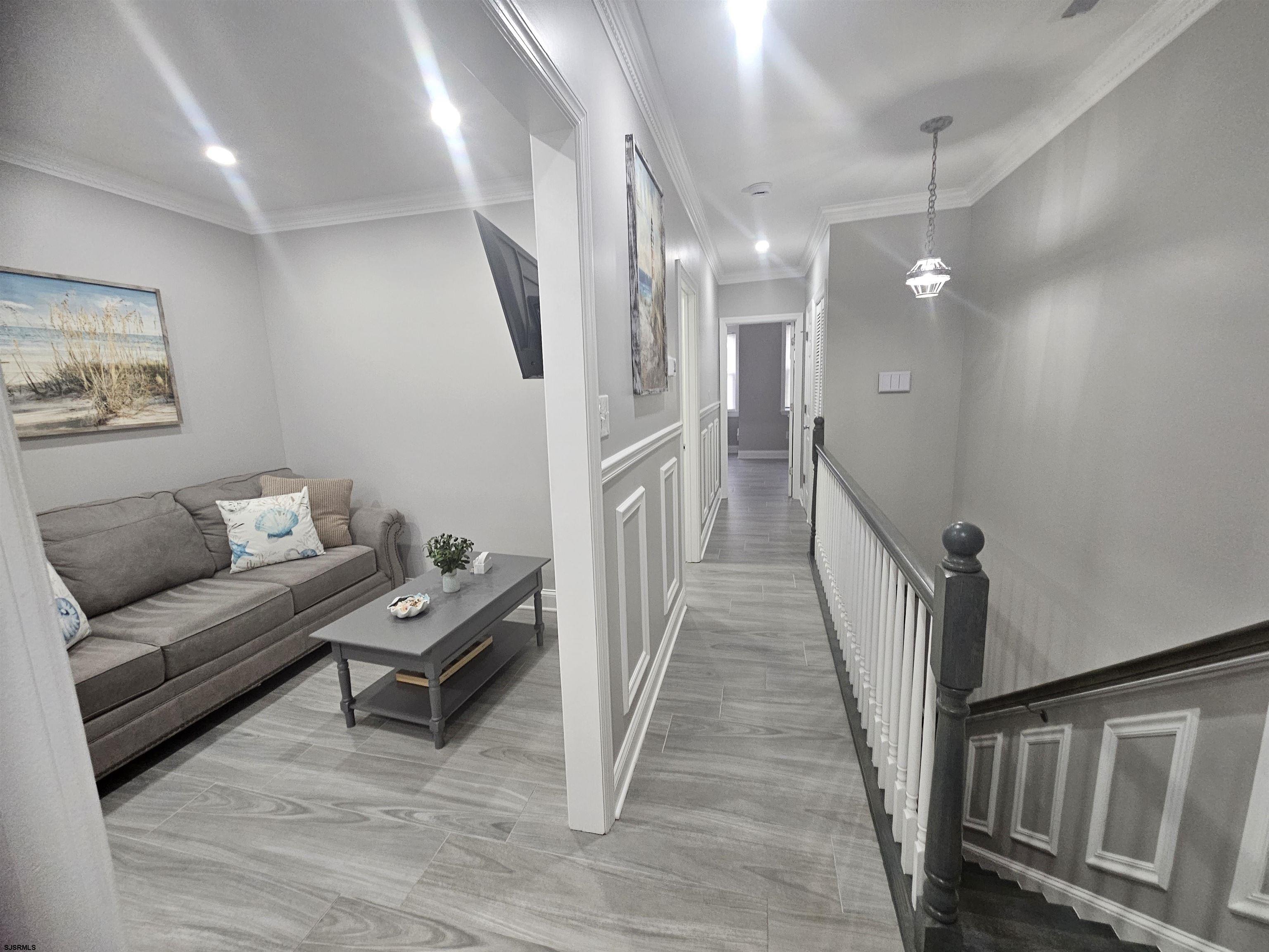 4009 Ventnor, Unit 2 Atlantic City, NJ 08401 - Photo 30 of 32 a living room with furniture and a wooden floor