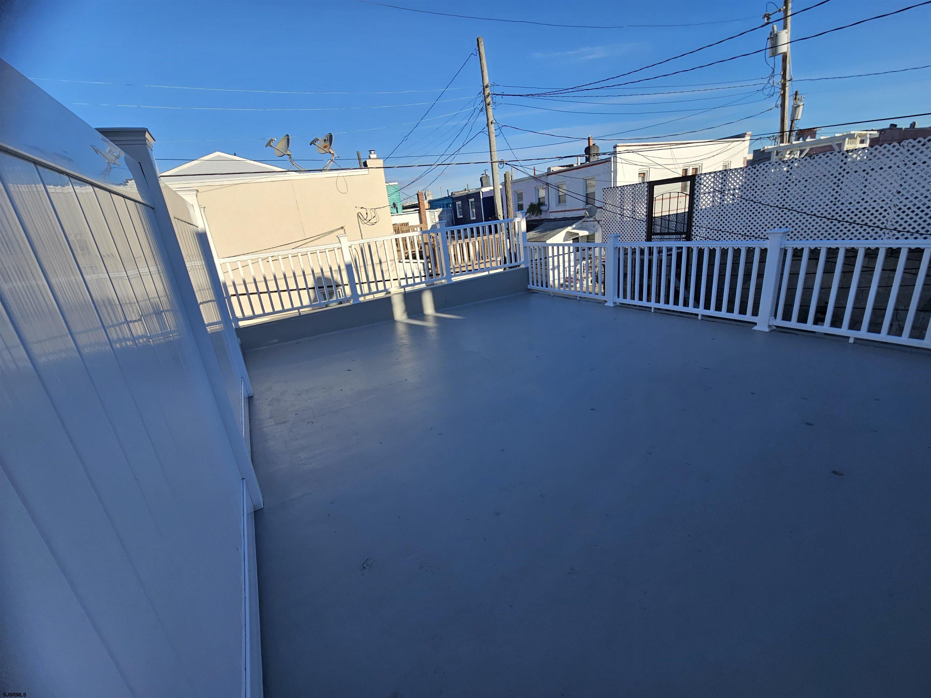 4009 Ventnor, Unit 2 Atlantic City, NJ 08401 - Photo 5 of 32 a view of a terrace with glass door and deck