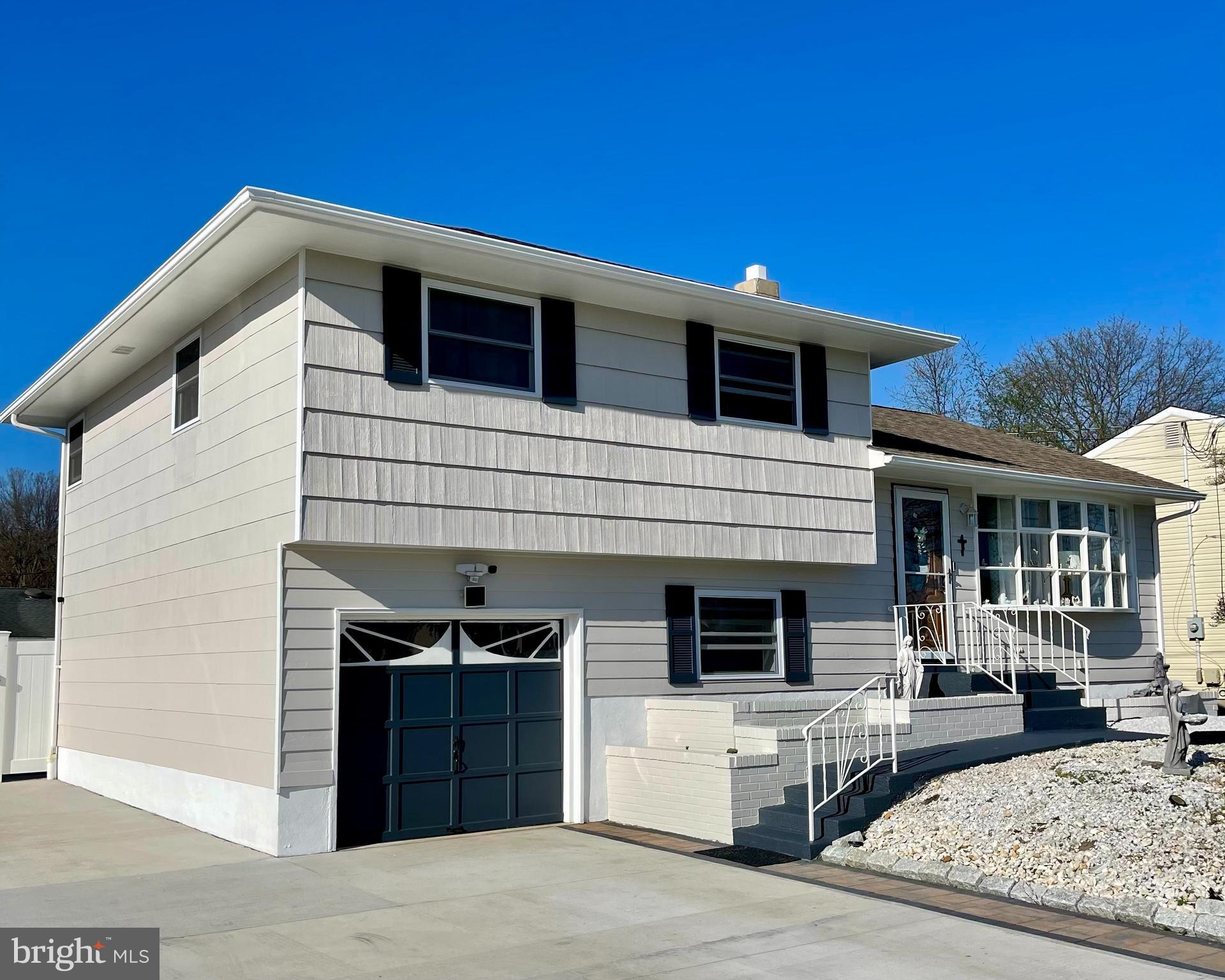 858 Estates Boulevard Hamilton, NJ 08690 - Photo 1 of 1 a front view of a house with a garage