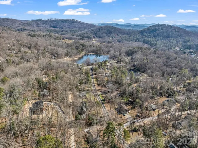 a view of a dry yard with mountains in the background