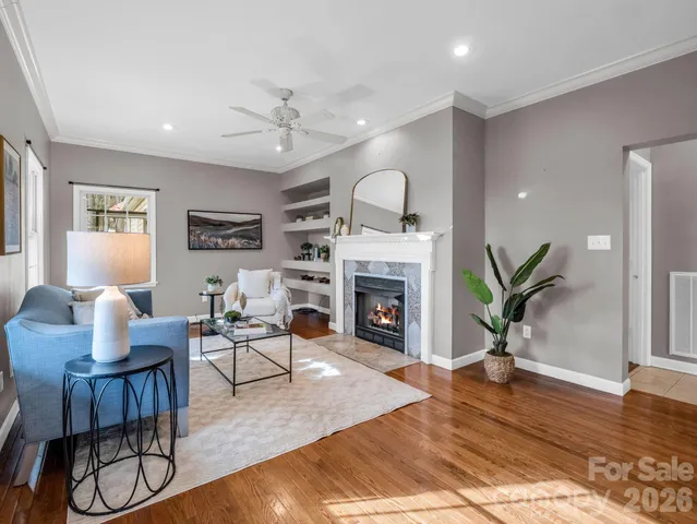 a living room with furniture a fireplace and wooden floor