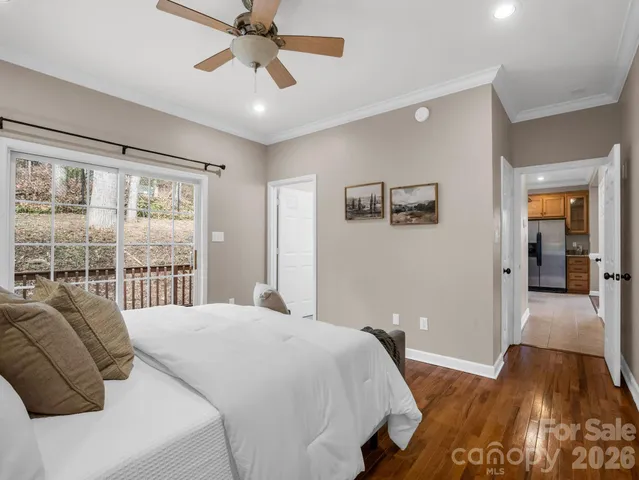 a bedroom with a bed and a large window