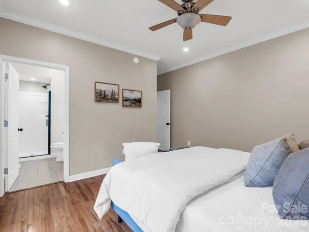 a bedroom with a large bed and a ceiling fan