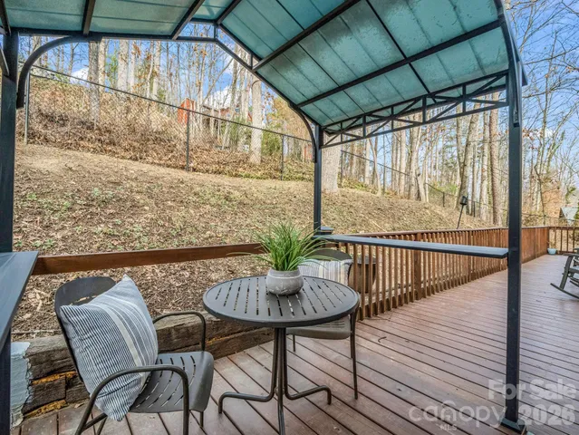 a balcony with table and chairs