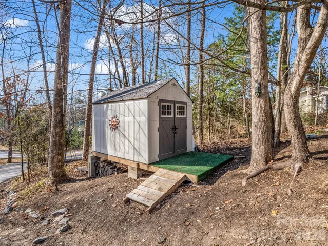 a wooden bench sitting in front of a house