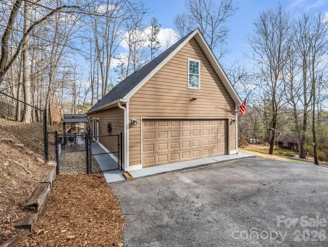 a view of a house with a yard and garage