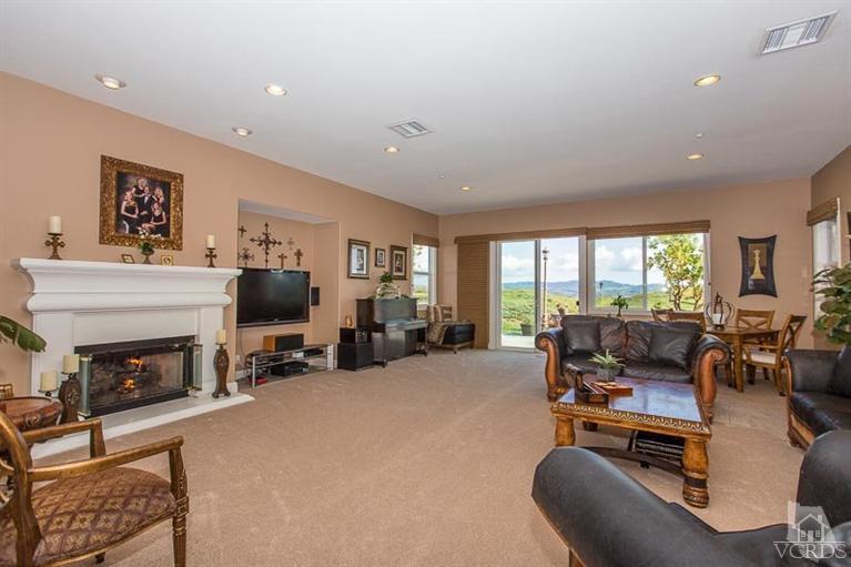 7216 Littler Court Moorpark, CA 93021 - Photo 11 of 92 a living room with furniture flat screen tv and a fireplace