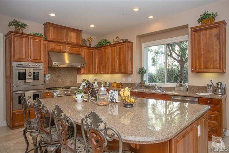 7216 Littler Court Moorpark, CA 93021 - Photo 17 of 92 a kitchen with sink a refrigerator and cabinets