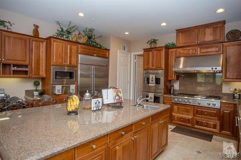 7216 Littler Court Moorpark, CA 93021 - Photo 20 of 92 a kitchen with stainless steel appliances granite countertop a sink stove and refrigerator