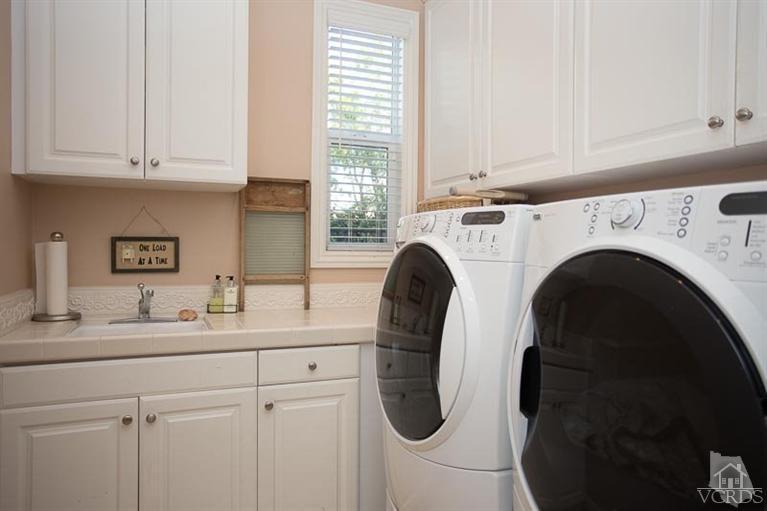 7216 Littler Court Moorpark, CA 93021 - Photo 21 of 92 a kitchen with stainless steel appliances white cabinets and a sink