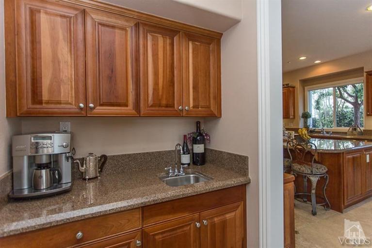 7216 Littler Court Moorpark, CA 93021 - Photo 23 of 92 a kitchen with stainless steel appliances granite countertop a sink a stove and a wooden cabinets