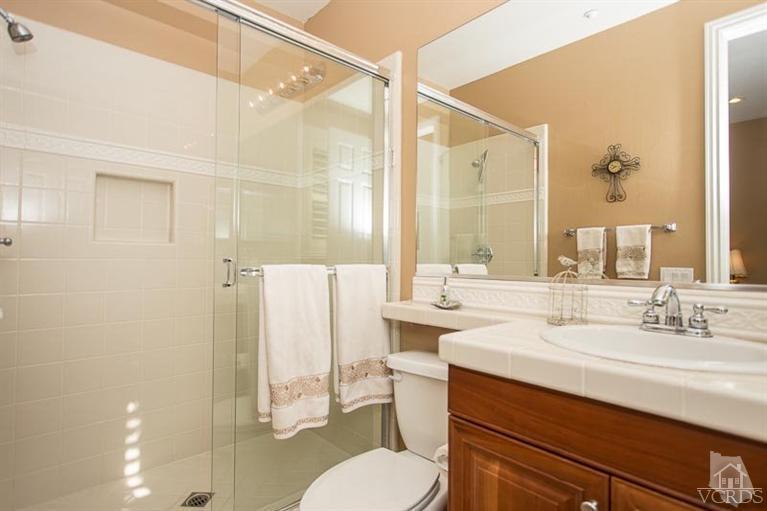 7216 Littler Court Moorpark, CA 93021 - Photo 27 of 92 a bathroom with a sink vanity mirror and toilet