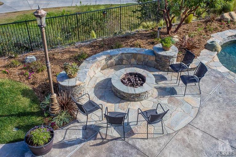 7216 Littler Court Moorpark, CA 93021 - Photo 39 of 92 a table with chairs and a vase of flower sitting on a table with chairs