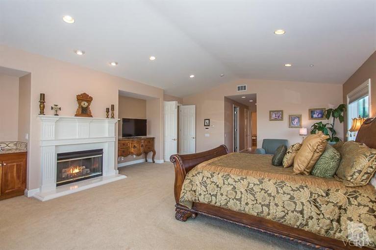 7216 Littler Court Moorpark, CA 93021 - Photo 42 of 92 a bedroom with a large bed and a fireplace