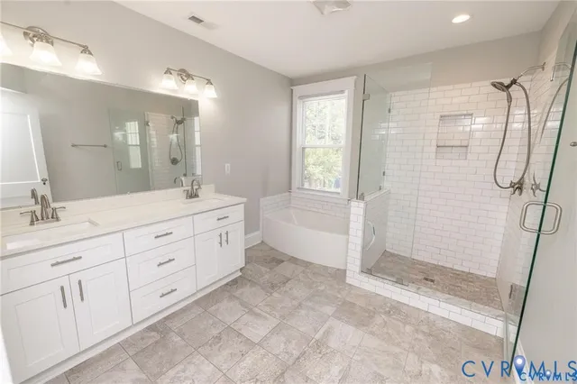 a spacious bathroom with double sink shower and two mirror