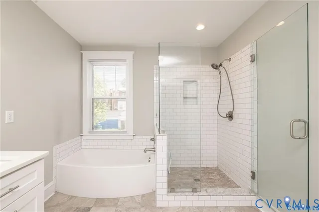 a bathroom with a bathtub a shower a toilet and a sink