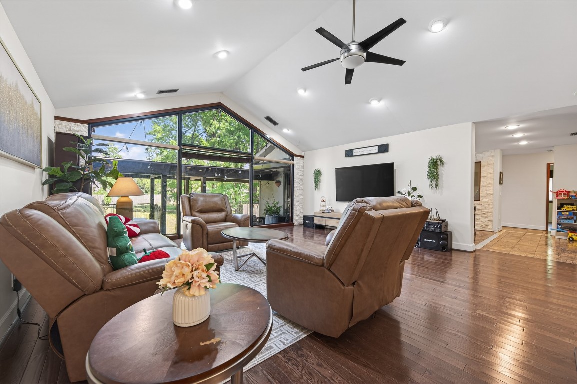 16914 Creeksouth Road Houston, TX 77068 - Photo 23 of 50 a living room with furniture floor to ceiling window and a flat screen tv