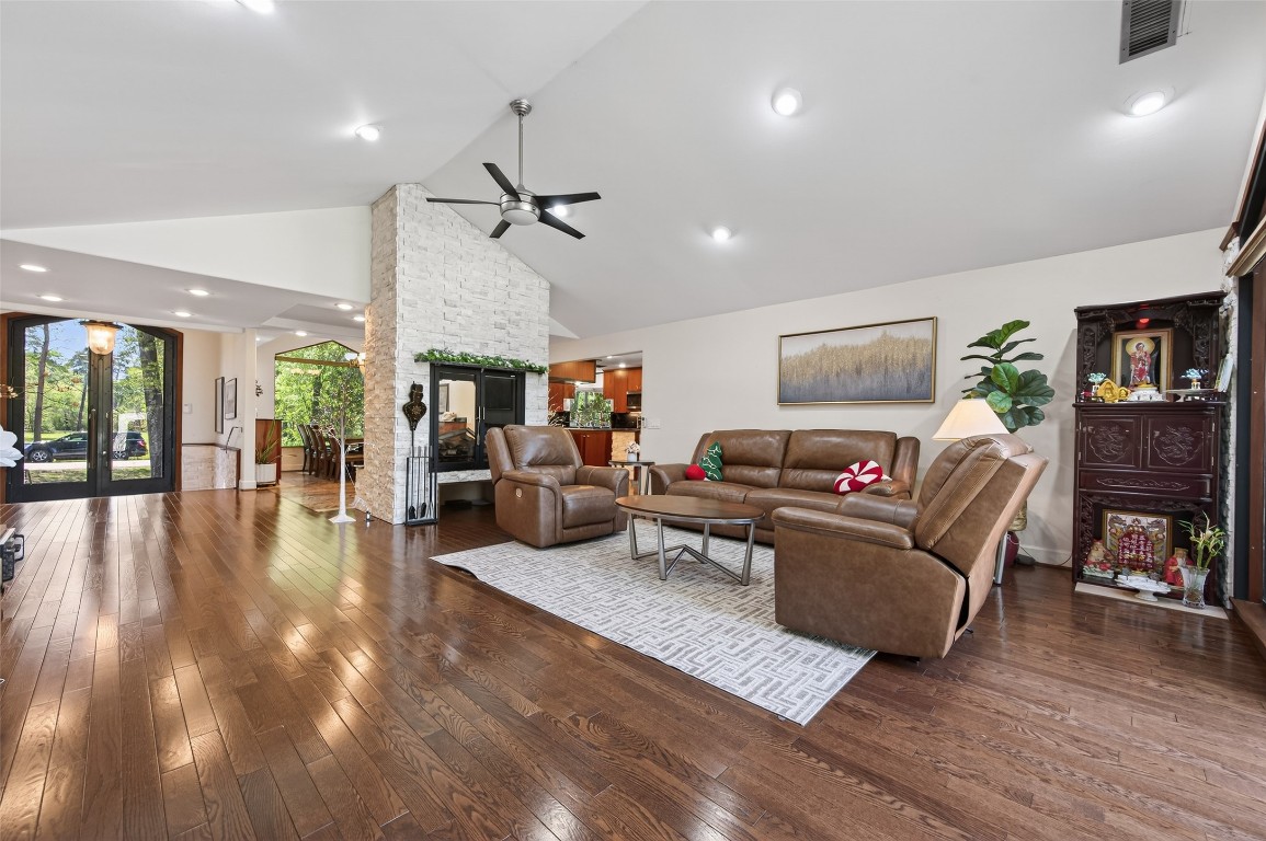16914 Creeksouth Road Houston, TX 77068 - Photo 25 of 50 a living room with furniture and a fireplace
