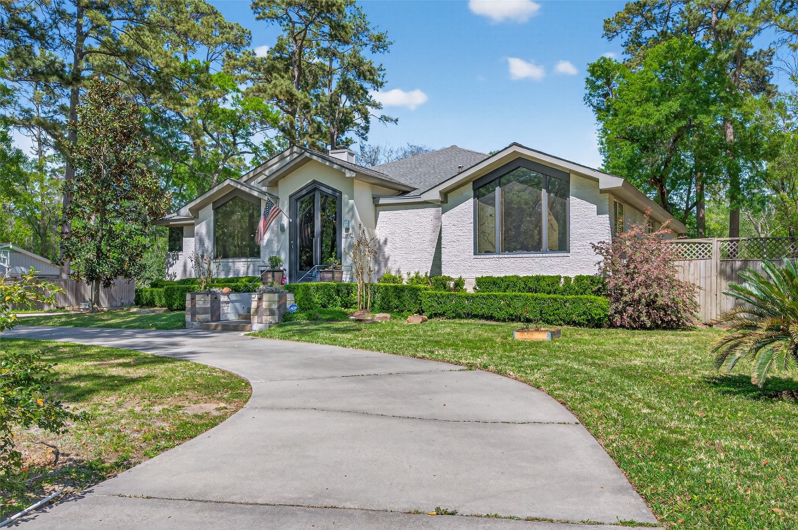 16914 Creeksouth Road Houston, TX 77068 - Photo 3 of 50 a front view of a house with a yard and trees