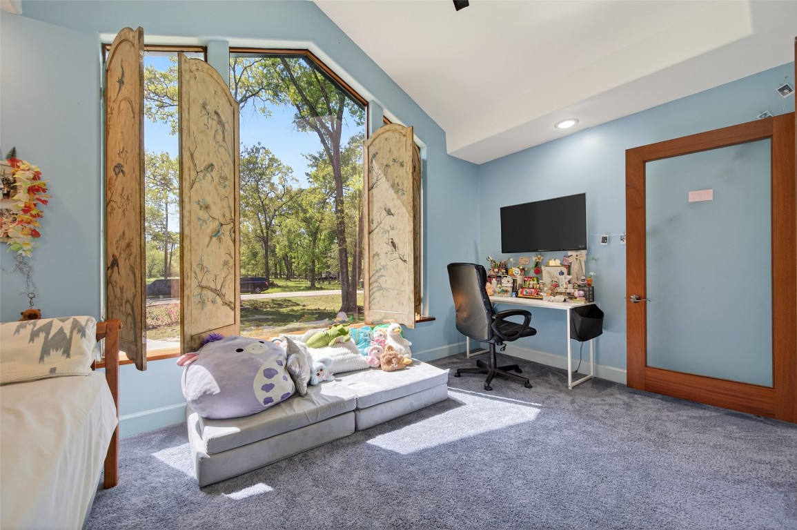 16914 Creeksouth Road Houston, TX 77068 - Photo 33 of 50 a living room with furniture and a flat screen tv