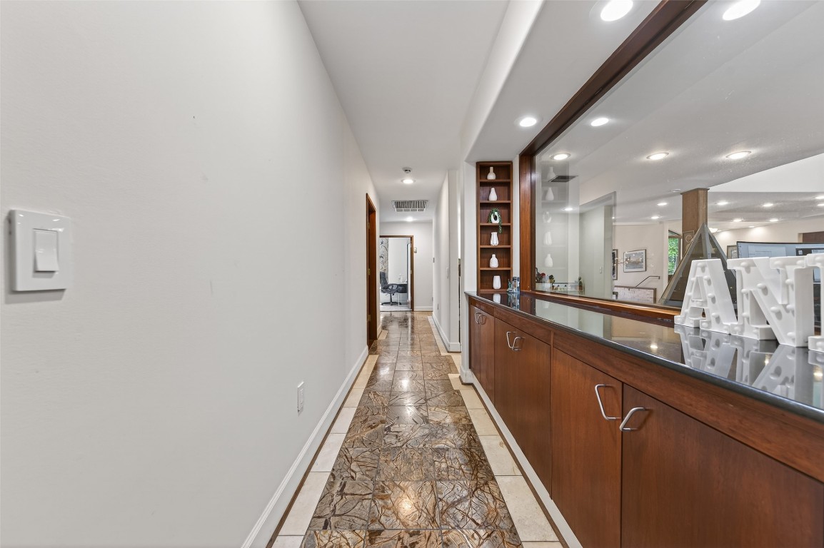 16914 Creeksouth Road Houston, TX 77068 - Photo 40 of 50 a view of a hallway with wooden floor and staircase