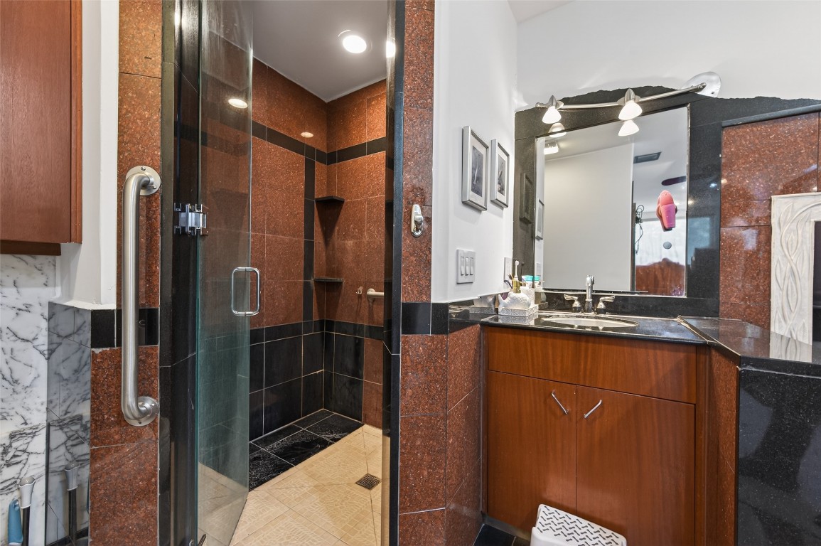 16914 Creeksouth Road Houston, TX 77068 - Photo 47 of 50 a bathroom with a mirror and a shower