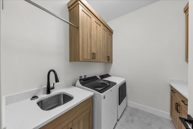 404 North Marsala Way St. George, UT 84770 - Photo 16 of 26 Laundry area with washer and dryer and cabinet space