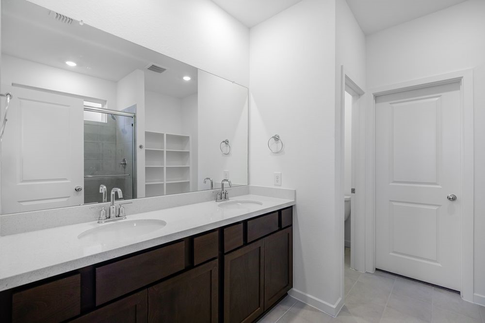 22119 Strathfield Circle Cypress, TX 77433 - Photo 13 of 37 a bathroom with a sink double vanity and a mirror