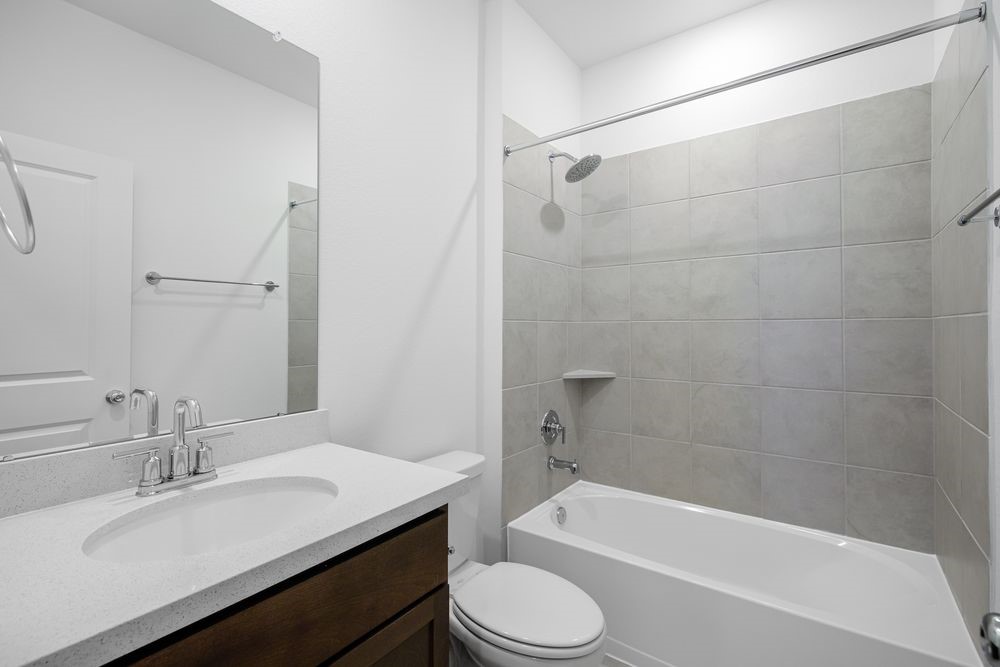 22119 Strathfield Circle Cypress, TX 77433 - Photo 18 of 37 a bathroom with a sink a toilet and bathtub