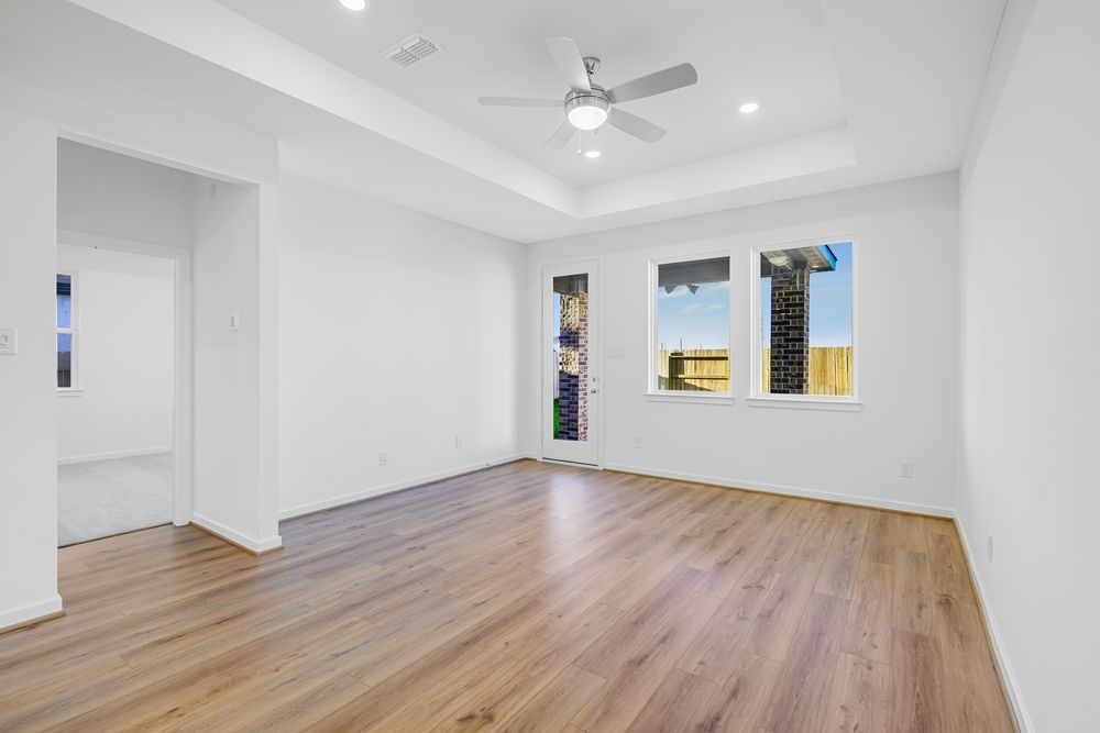 22119 Strathfield Circle Cypress, TX 77433 - Photo 5 of 37 a view of an empty room with window and wooden floor