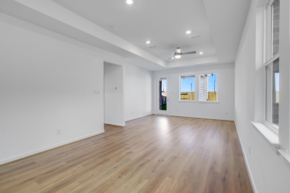 22119 Strathfield Circle Cypress, TX 77433 - Photo 6 of 37 an empty room with wooden floor and windows