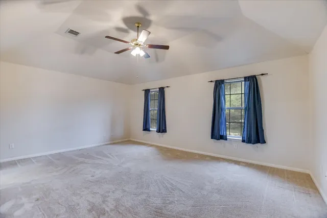 a view of a room with window and ceiling fan