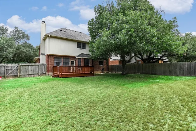 a view of a house with a backyard and a patio